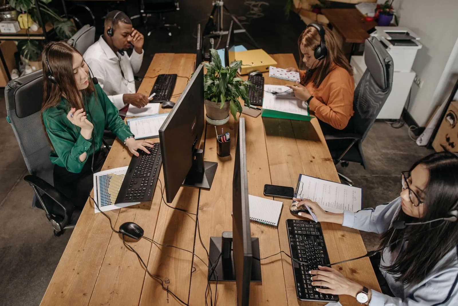 A support team answering calls at computer desks
