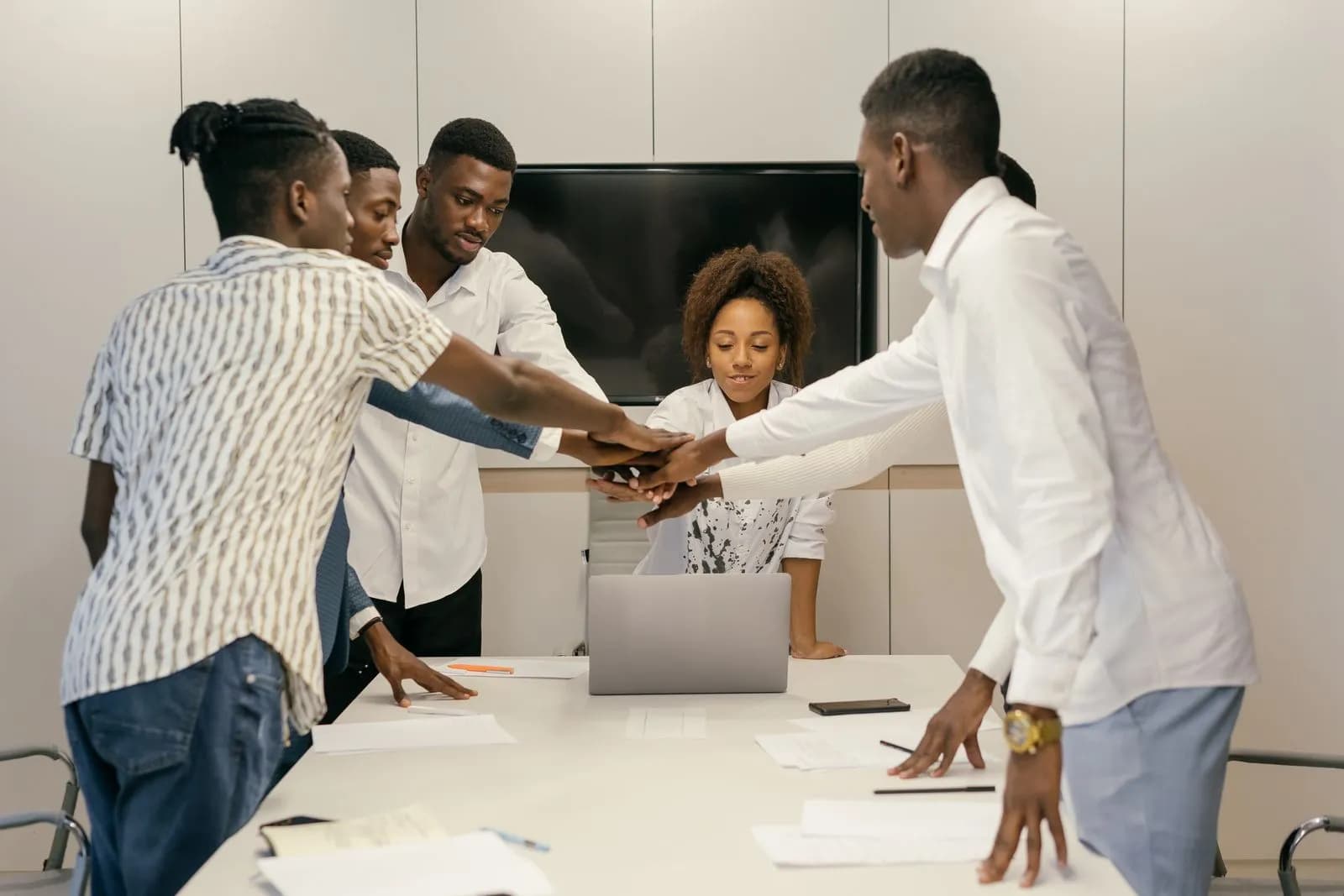 Diverse team engaged in a collaborative meeting around a table in a modern office setting.