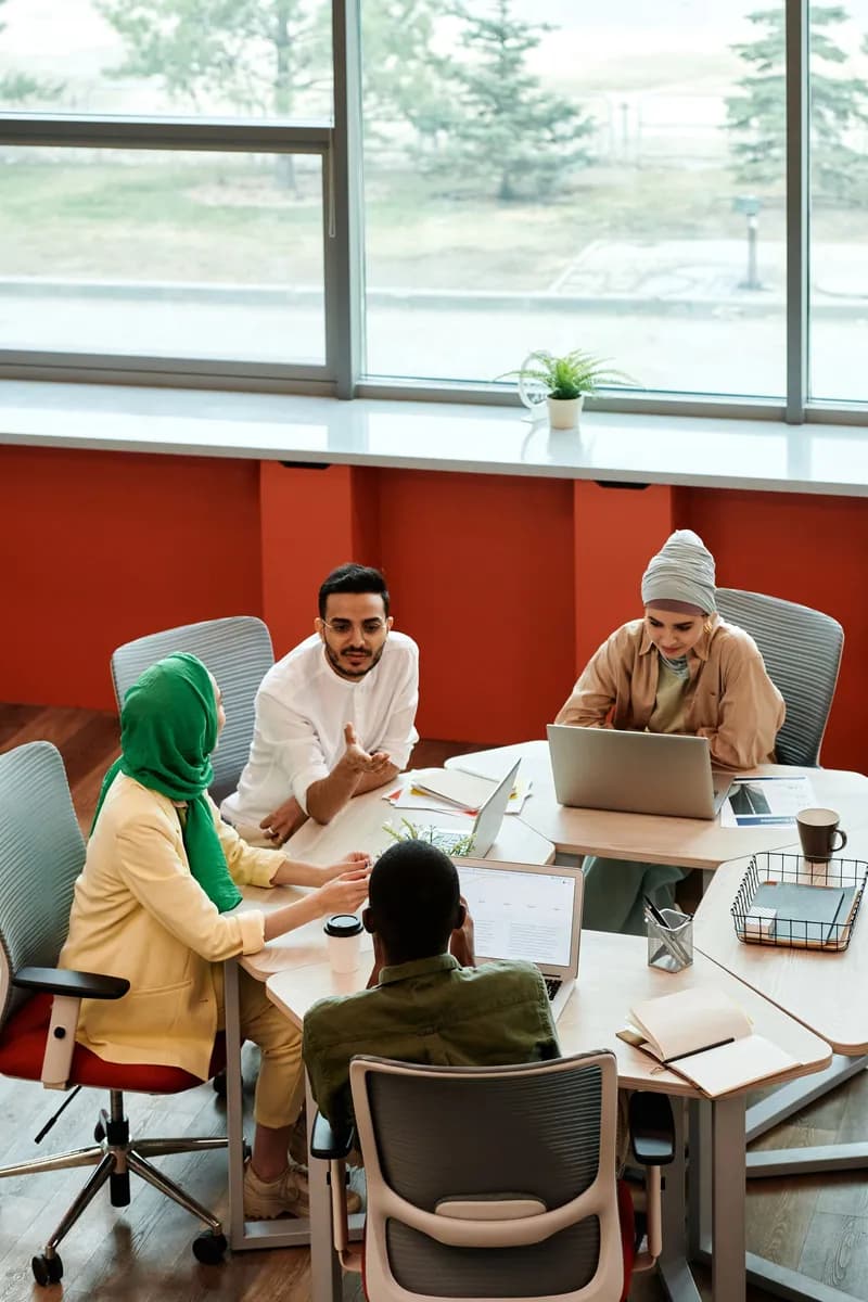 Business team meeting with diverse professionals working together in a modern office setting